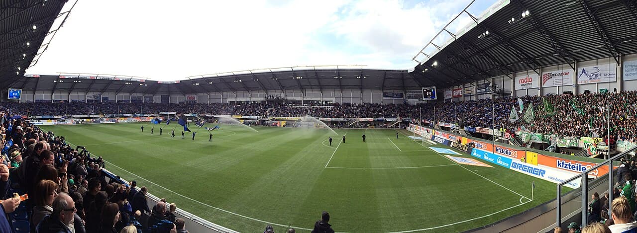 General view of an empty football stadium before kickoff, with the pitch and stands ready for a Bundesliga match