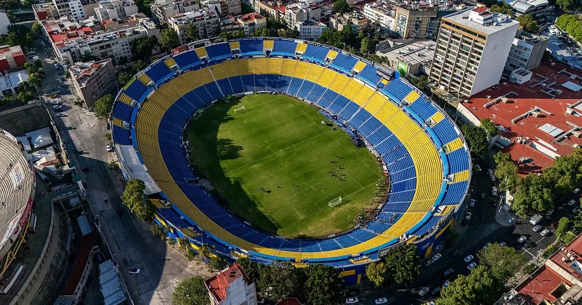 General view of a football stadium's pitch and stands before kickoff, under floodlights ahead of the match