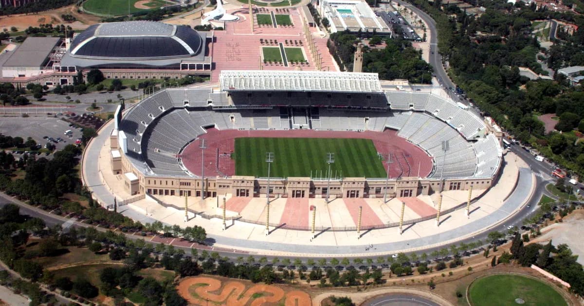 Wide view of a football stadium's pitch and stands before kickoff